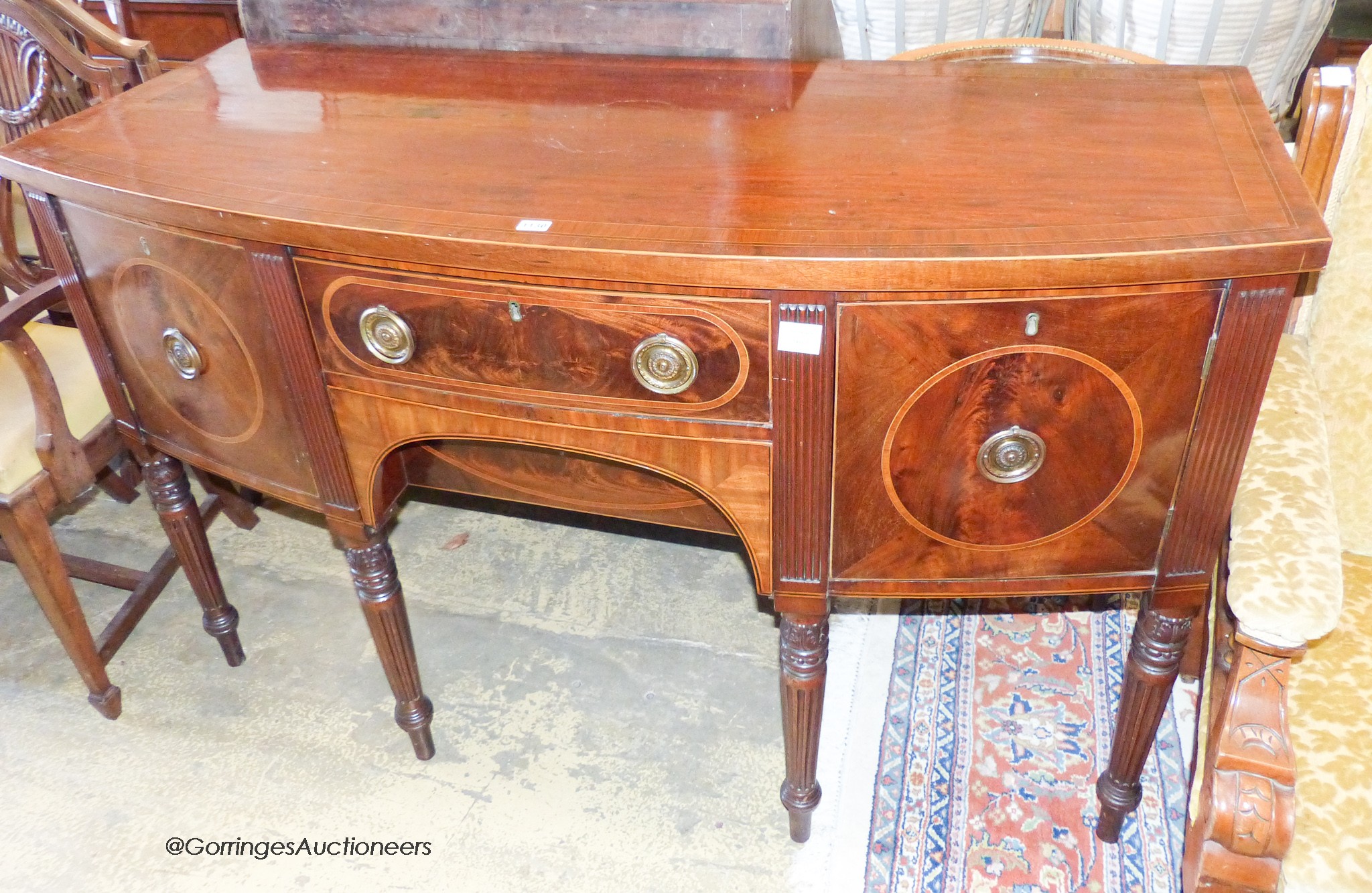 A George IV banded mahogany bow front sideboard, length 152cm, depth 65cm, height 94cm